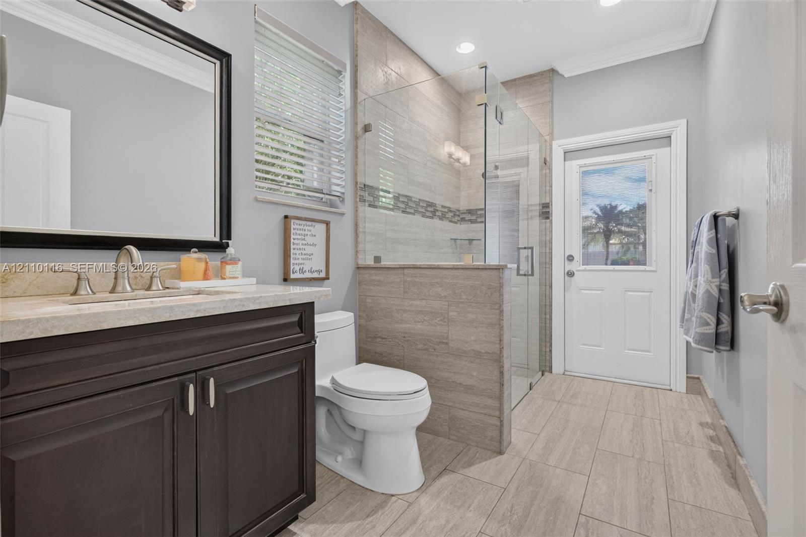 Cabana Bathroom leading to pool & patio; shower enclosure with glass walls