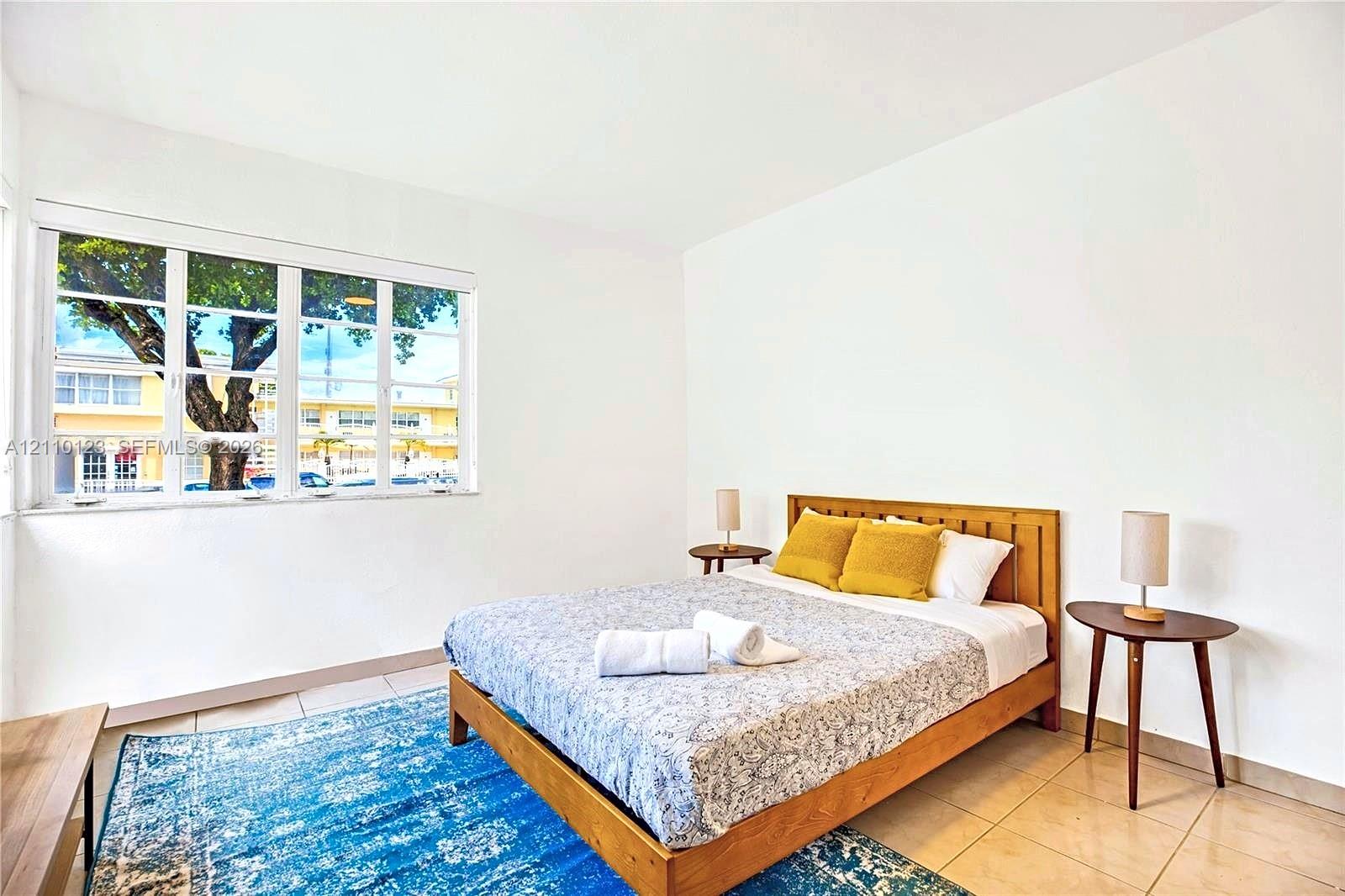 Interior space featuring large multi-pane windows and tile flooring