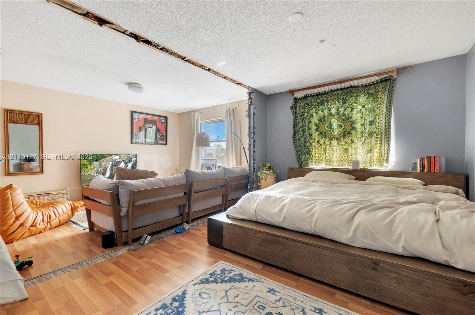 Open-concept interior featuring wood-finish flooring and windows with natural light