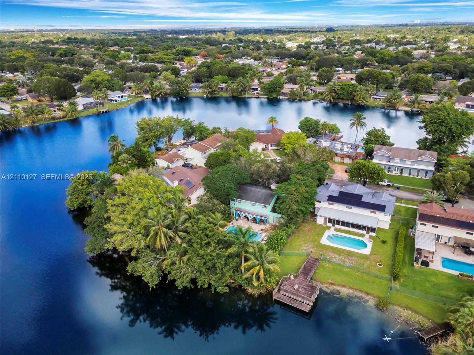 Aerial perspective of waterfront properties featuring deep-water access, private swimming pools, and dedicated dock structures Aerial perspective of waterfront properties featuring deep-water access, private swimming pools, and dedicated dock structures