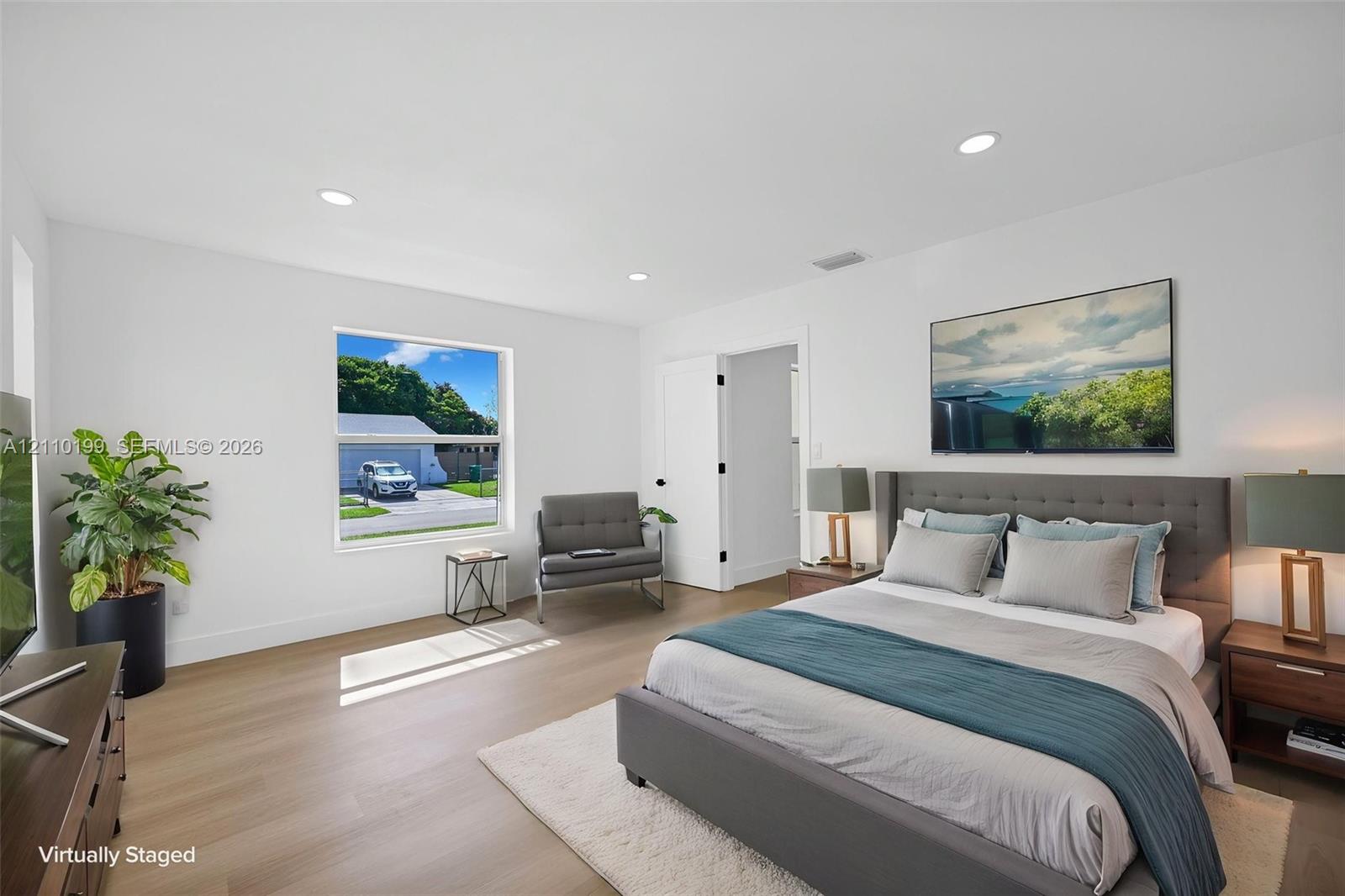 Bedroom featuring wood-finish flooring, recessed lighting, and a single-pane window