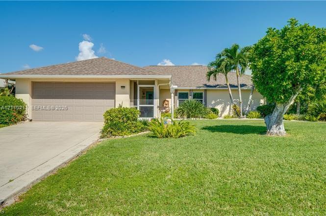 Single-story residence featuring a hipped roof, concrete driveway, attached two-car garage, and a screened entry Single-story residence featuring a hipped roof, concrete driveway, attached two-car garage, and a screened entry