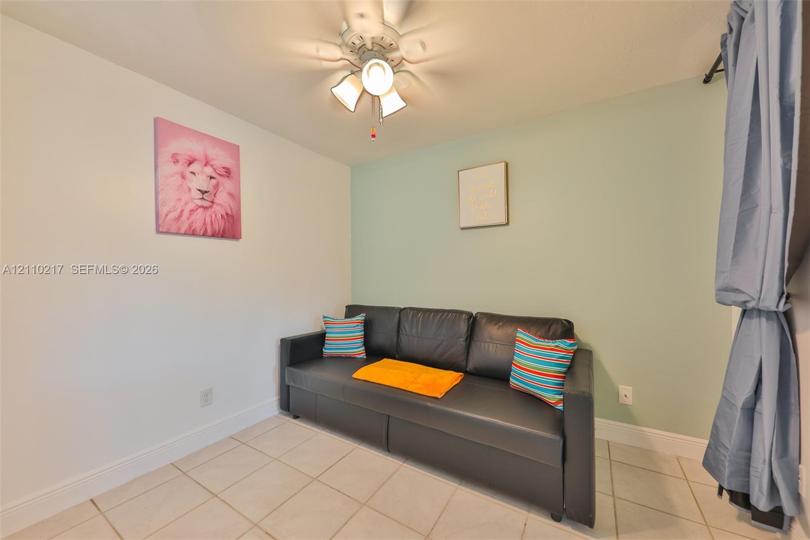 Ceramic tile flooring and a multi-bulb ceiling fan with an integrated light fixture