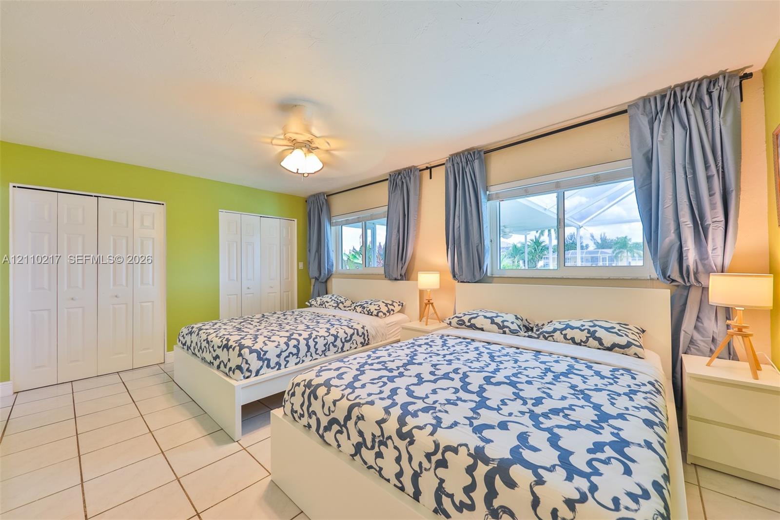 Tile flooring, dual sliding-door closets, and large dual windows featuring custom hardware