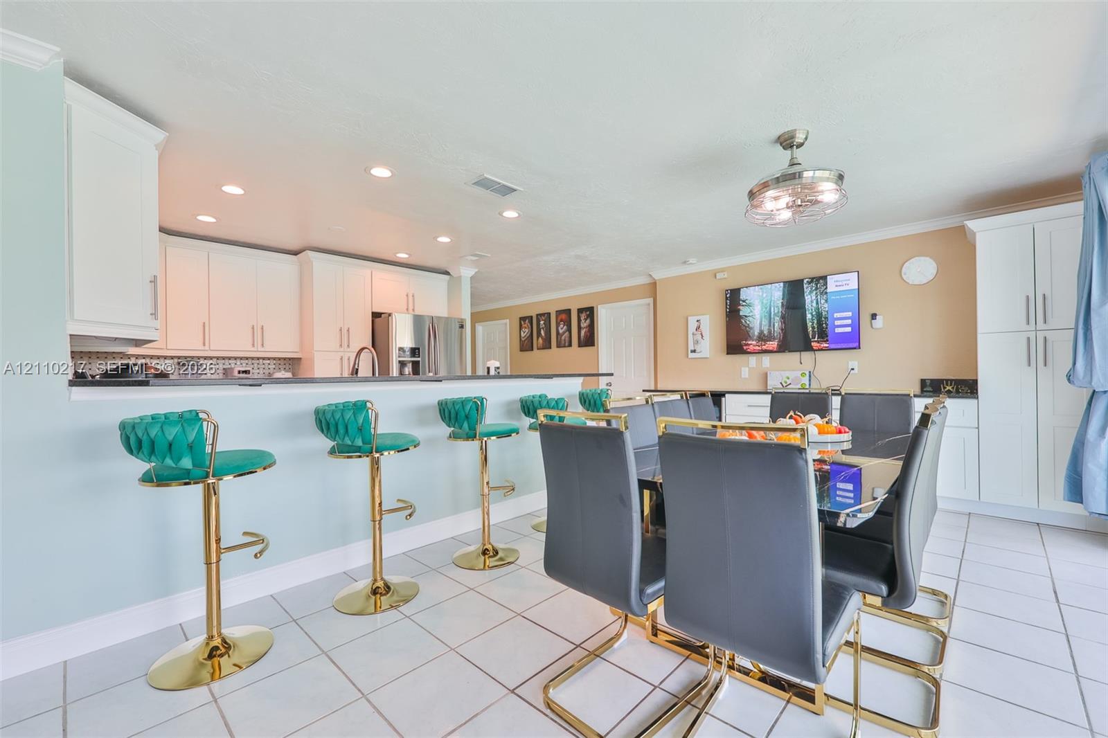 Kitchen featuring white cabinetry, a breakfast bar, recessed lighting, and tile flooring