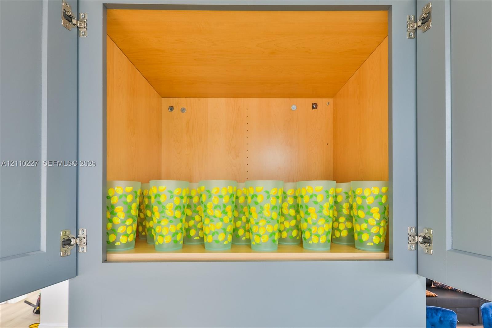 Custom blue-painted cabinetry with adjustable shelving and concealed hinges
