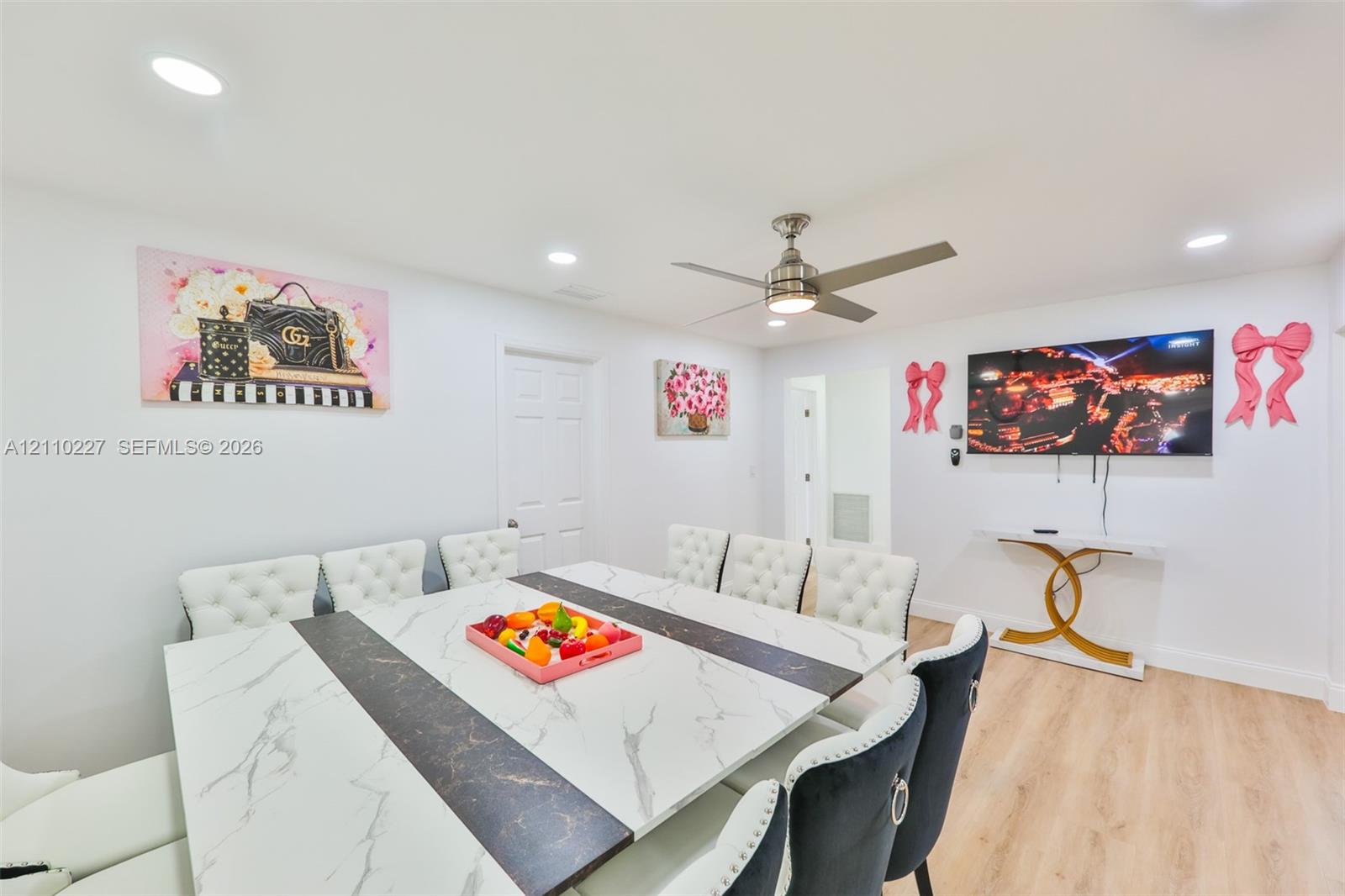 Open-concept room featuring recessed lighting, a brushed-nickel ceiling fan, and light-toned wood-finish flooring