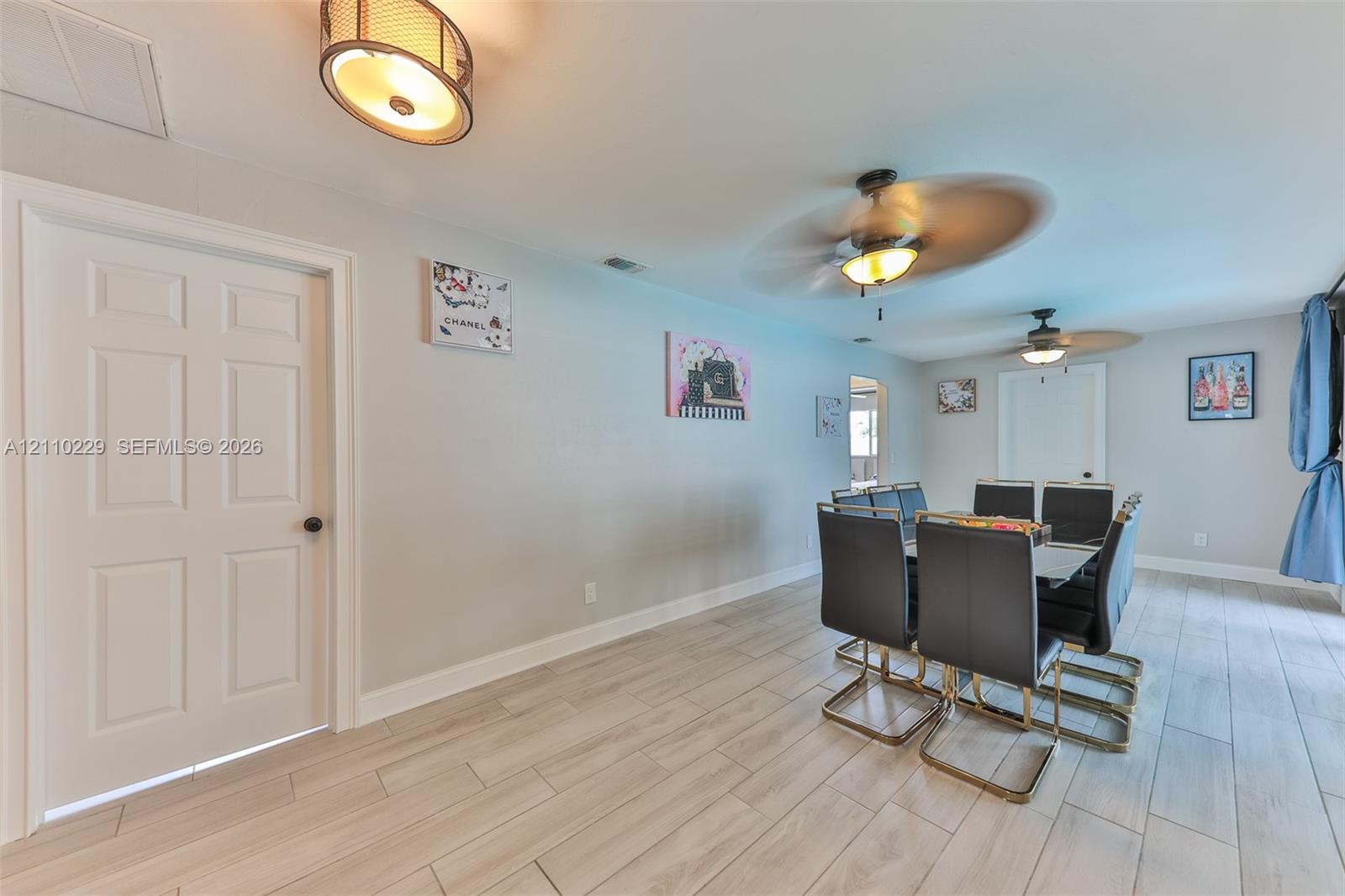 Neutral wall-finish, light-toned wood-finish flooring, recessed ceiling lighting, and dual ceiling fans
