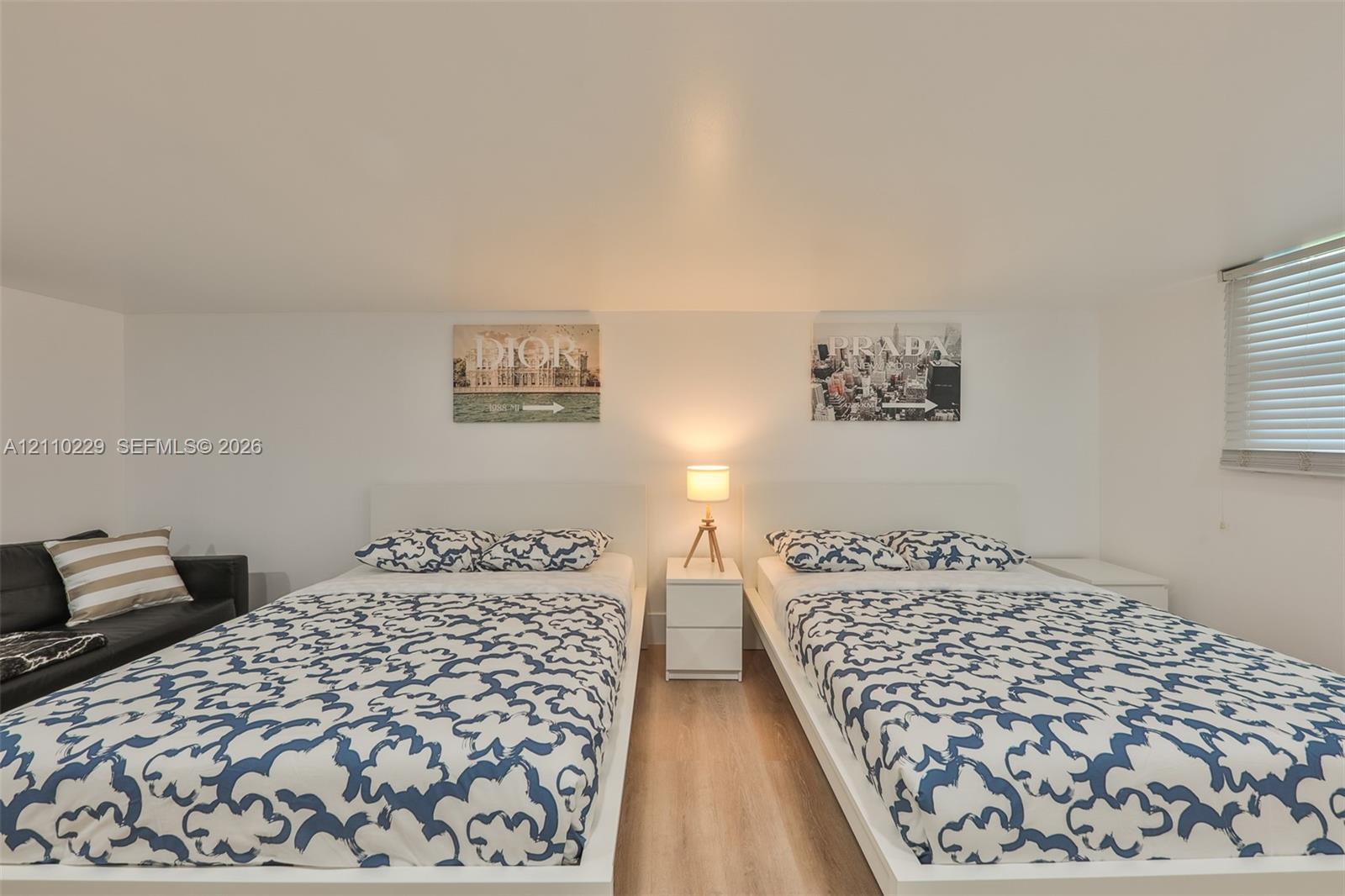 Interior space featuring wood-finish flooring and horizontal window blinds