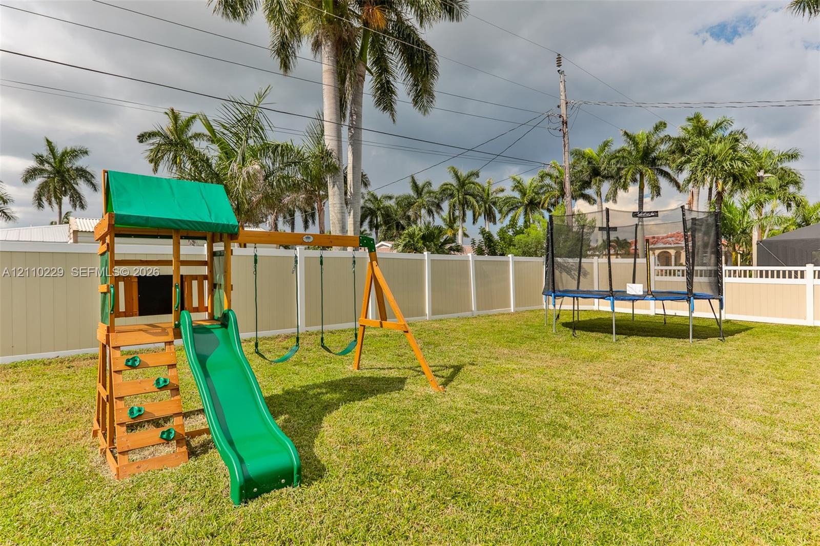 Fenced backyard featuring a manicured lawn and perimeter privacy fencing