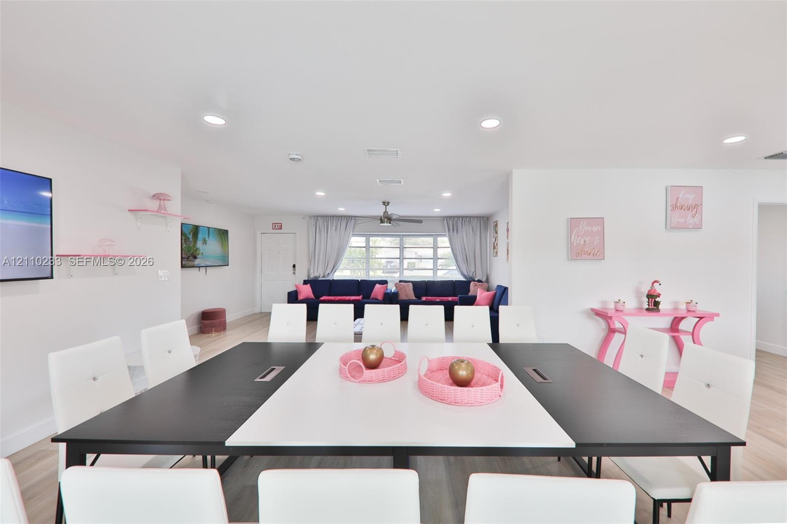 Open interior featuring recessed lighting, wood-finish flooring, and white wall-mounted shelving