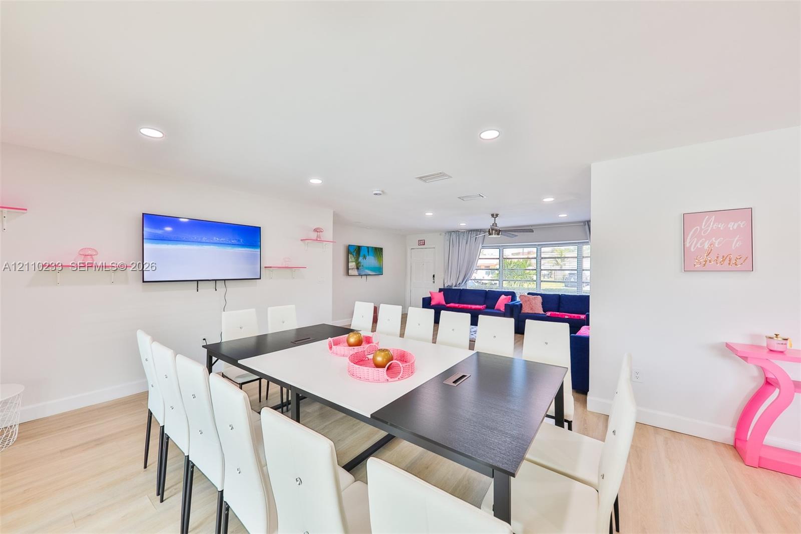 Open-concept room featuring wood-finish flooring, recessed lighting, and wall-mounted shelving