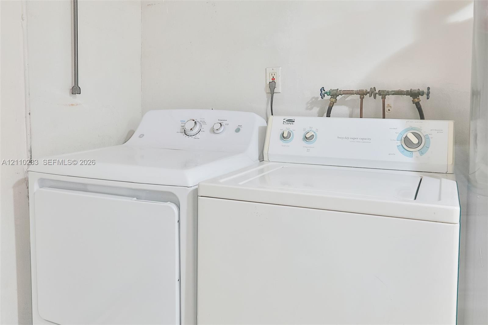 Laundry area equipped with washer and dryer hookups, electrical outlets, and plumbing connections