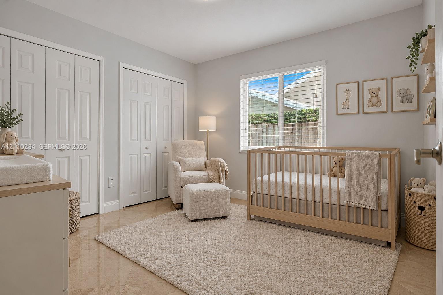 Neutral-toned interior featuring glossy tile flooring, dual bi-fold closet doors, and a multi-pane window with integrated blinds