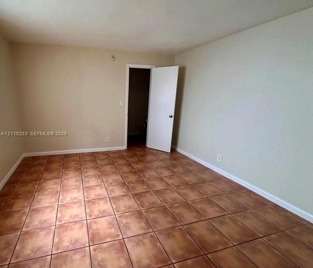 Neutral-toned walls and large-format ceramic tile flooring
