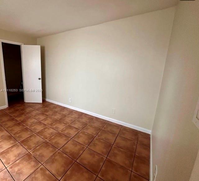 Neutral-toned wall finish and square tile flooring