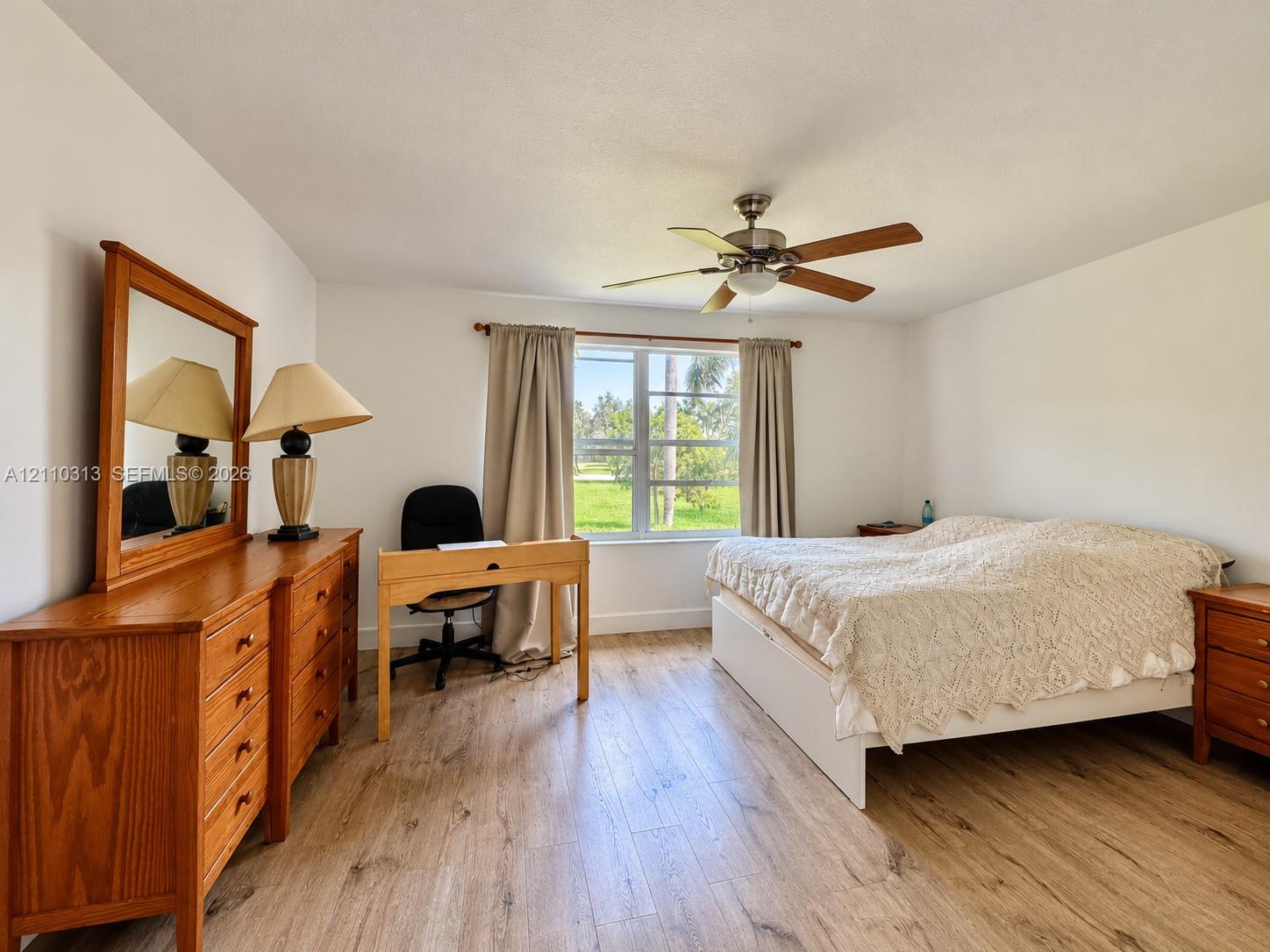 Wood-finish flooring, multi-pane window, and integrated ceiling fan with light fixture