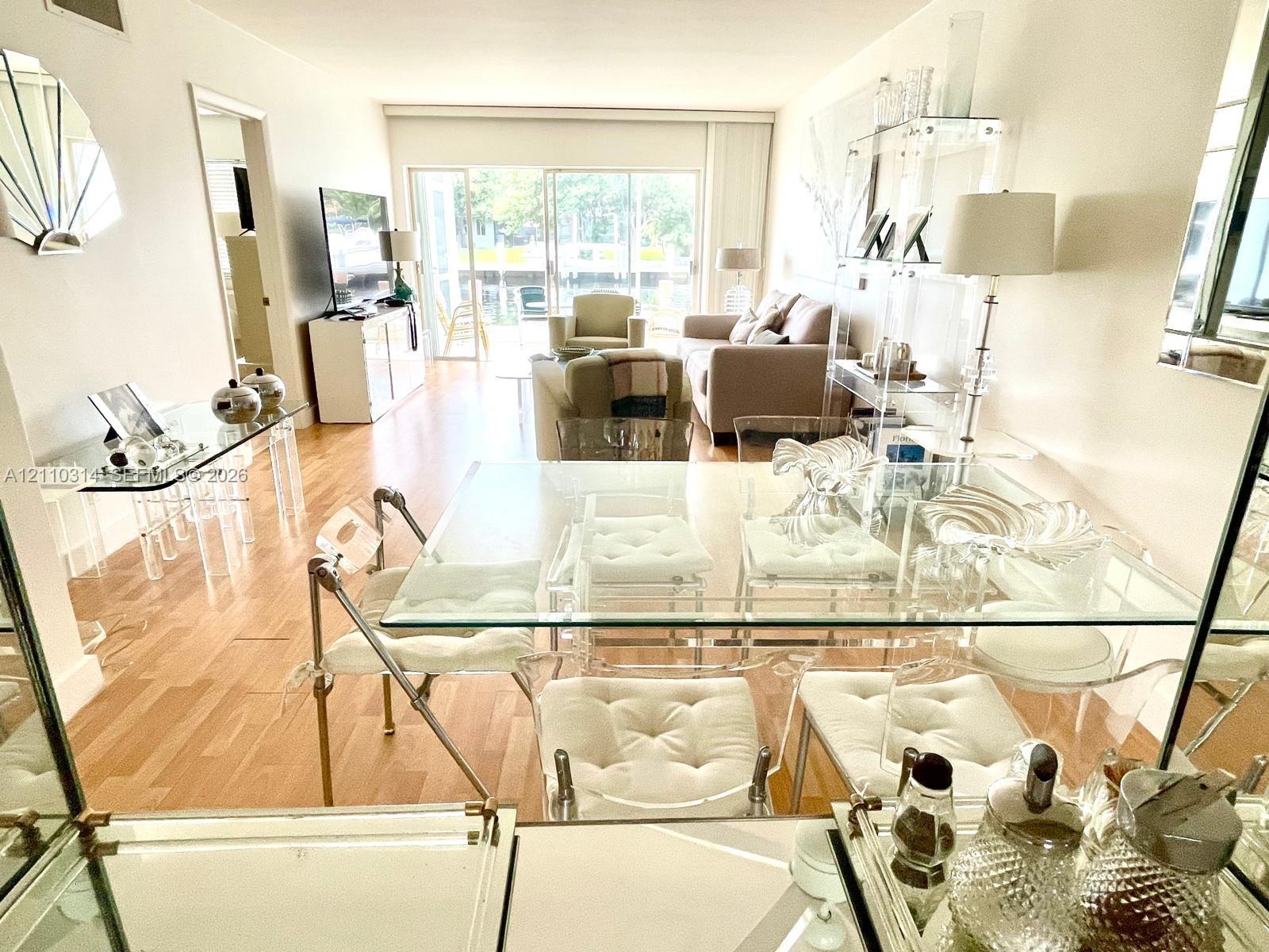 Open-concept living space featuring wood-finish flooring, floor-to-ceiling sliding glass doors, and recessed lighting