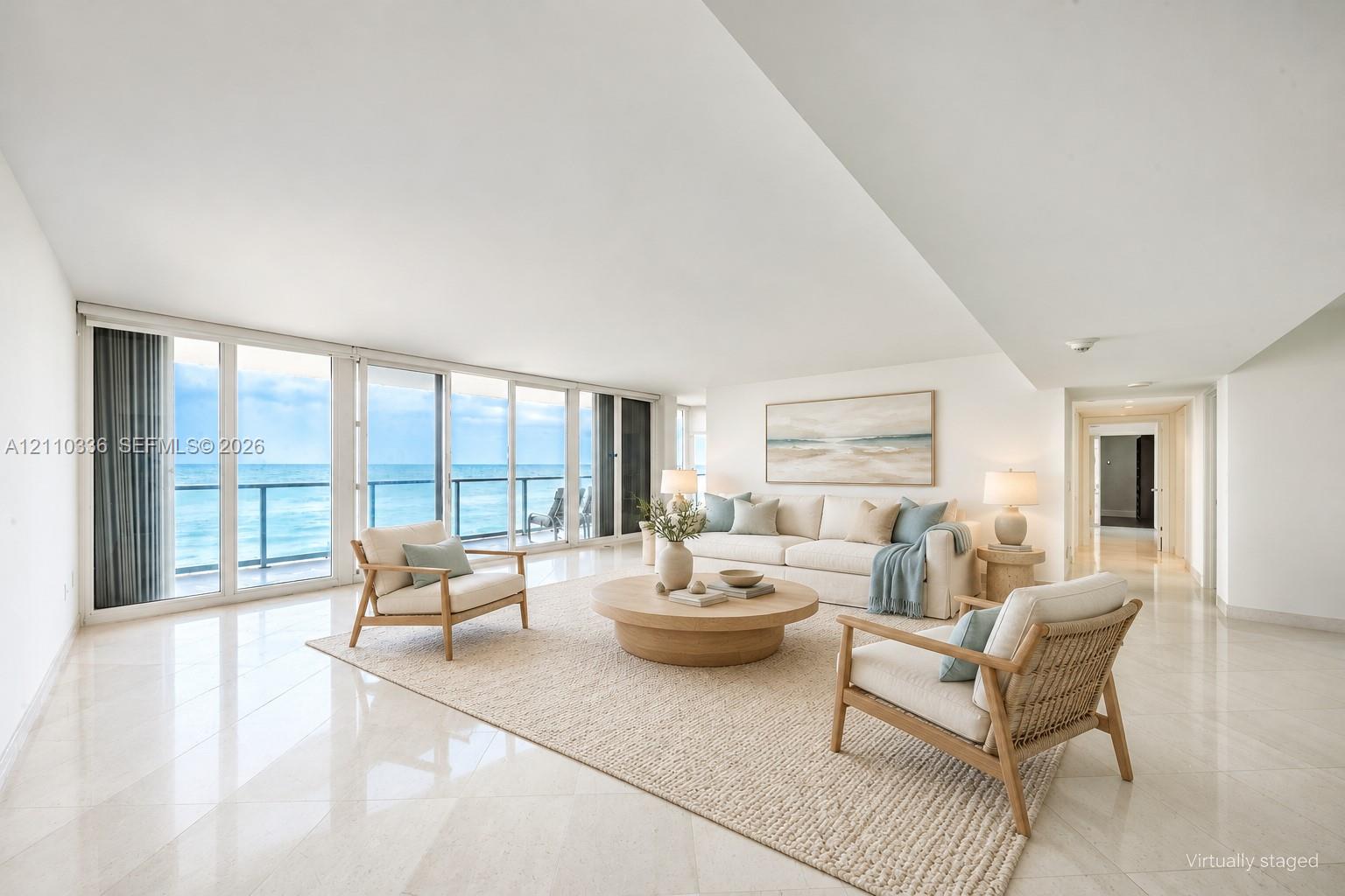 Open-concept interior featuring polished tile flooring, floor-to-ceiling glass panel sliding doors, and a private balcony Open-concept interior featuring polished tile flooring, floor-to-ceiling glass panel sliding doors, and a private balcony