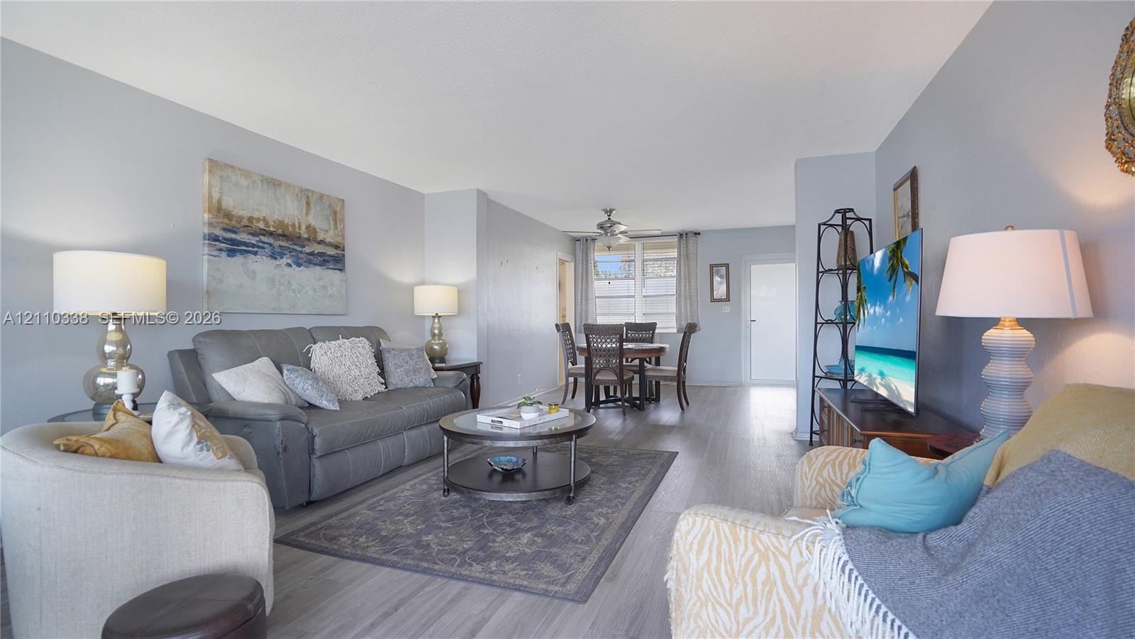Neutral-toned interior featuring wood-finish flooring, recessed lighting, and a ceiling fan