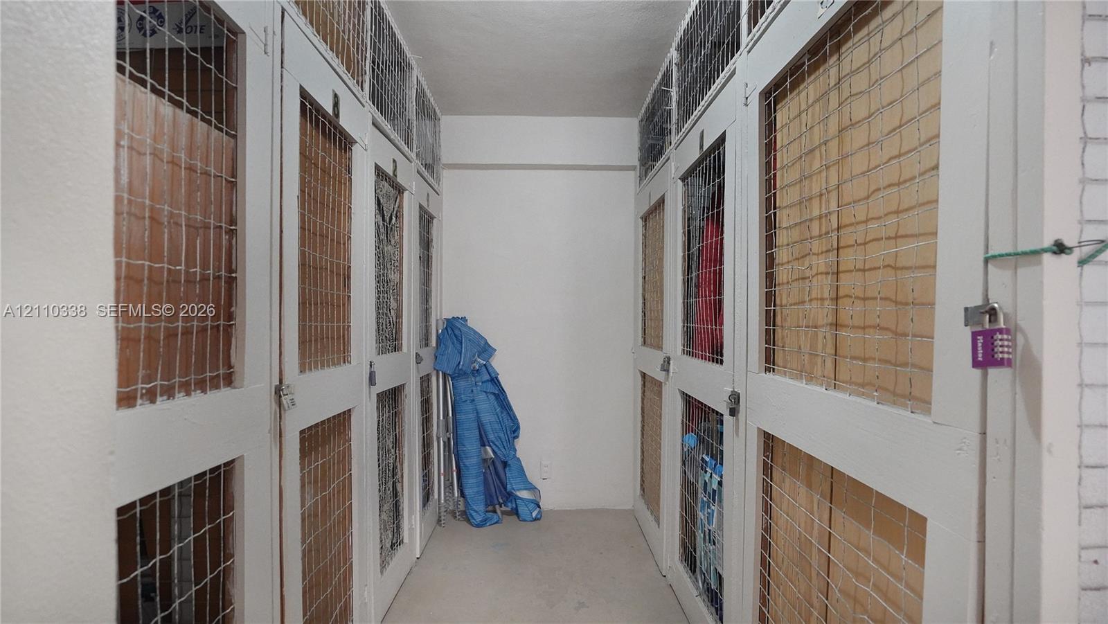Dedicated storage area featuring individual lockers with white-painted wood frames, integrated wire-mesh panels, and secure locking hardware