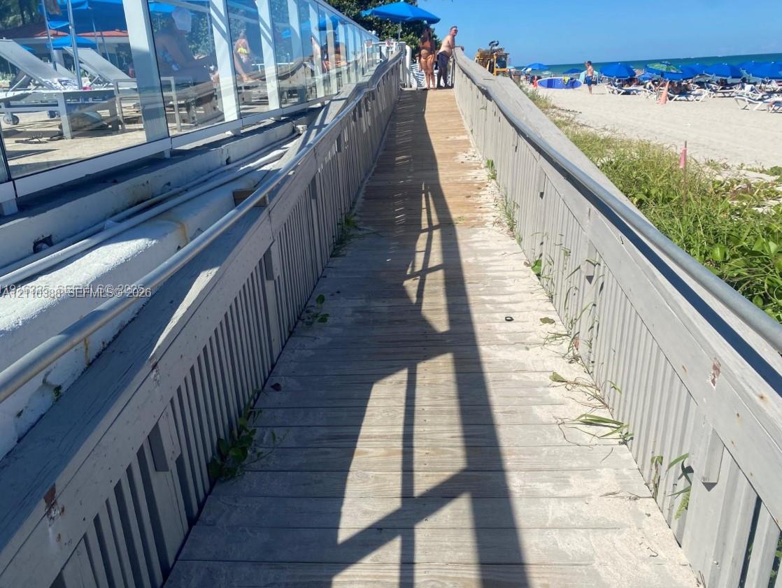 Raised wooden boardwalk with integrated metal railings