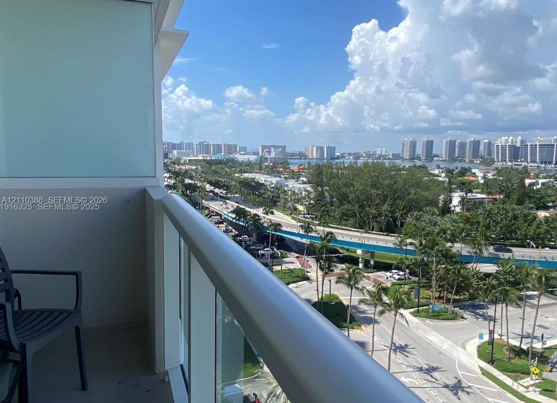 Private balcony featuring a glass-panel railing and concrete flooring