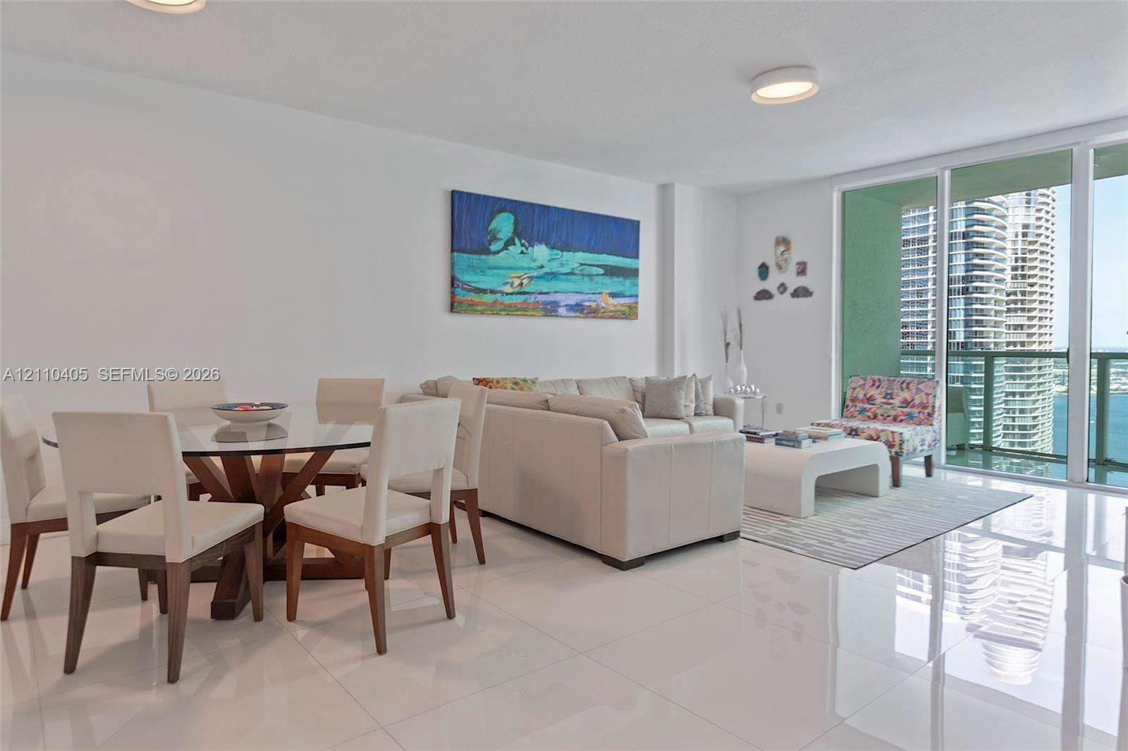 Polished porcelain tile flooring, floor-to-ceiling glass sliding doors, and recessed ceiling lighting