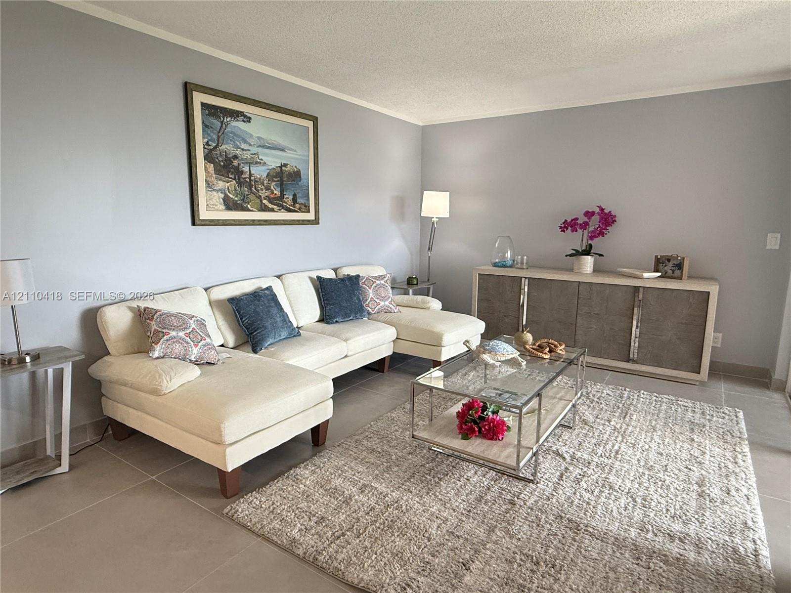 Neutral-toned wall finish featuring large-format ceramic tile flooring