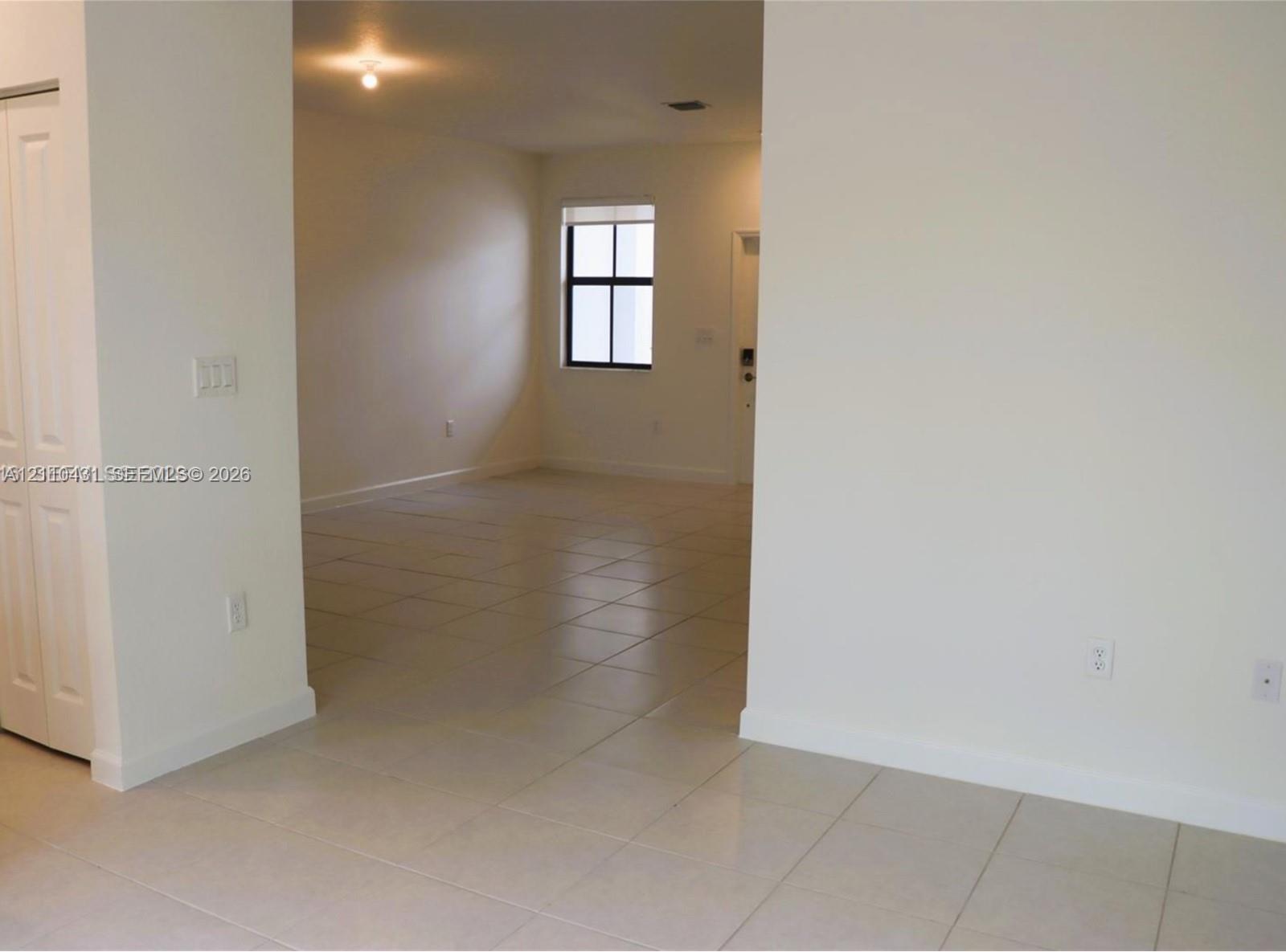 Neutral-toned ceramic tile flooring, interior closet with bi-fold doors, and recessed ceiling lighting