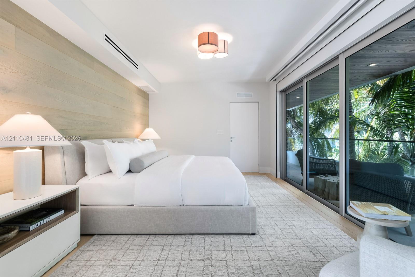 Wood-finish wall paneling, floor-to-ceiling sliding glass doors, recessed lighting, and flush-mount ceiling fixture