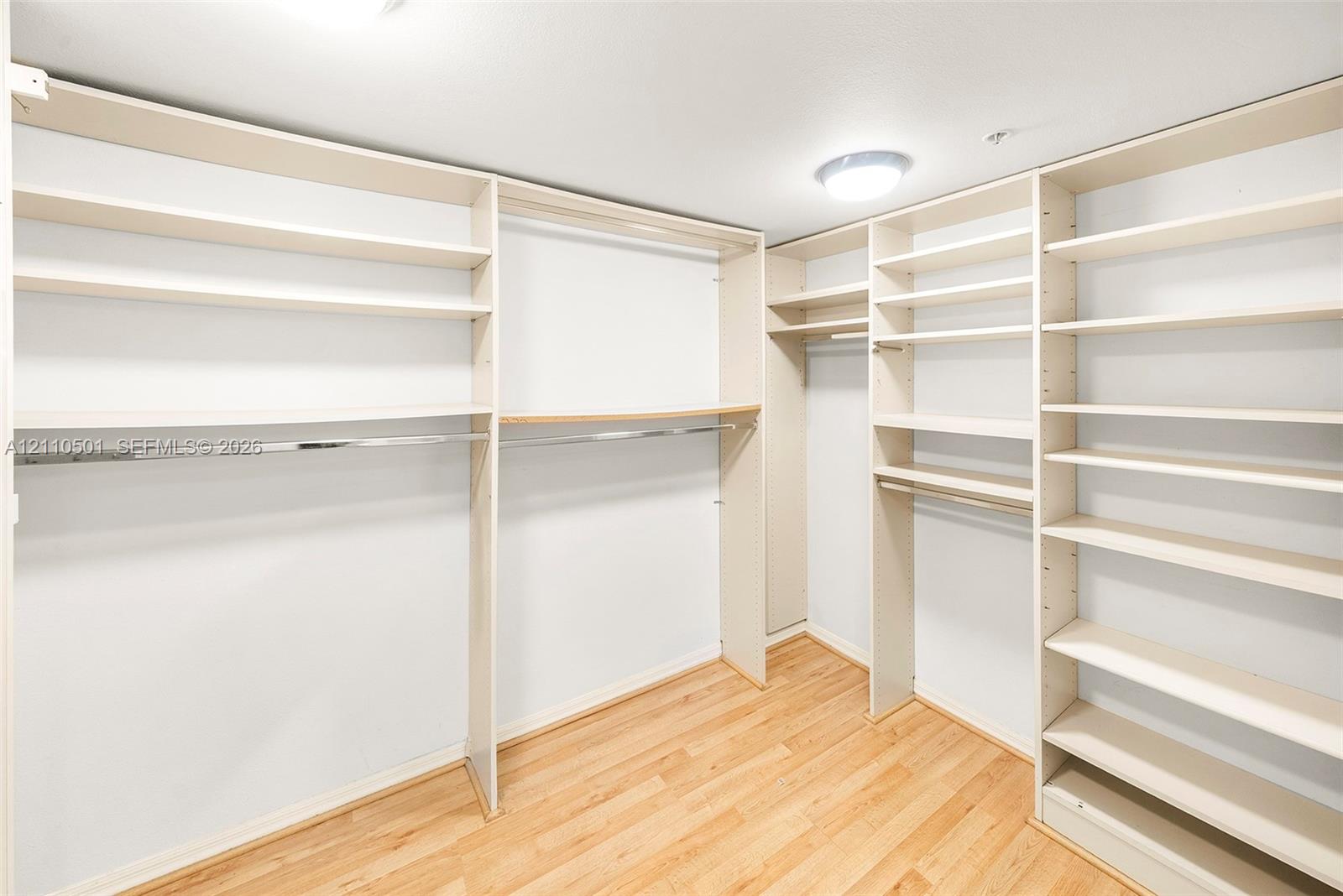 Primary Bedroom Walk-in closet featuring built-in shelving
