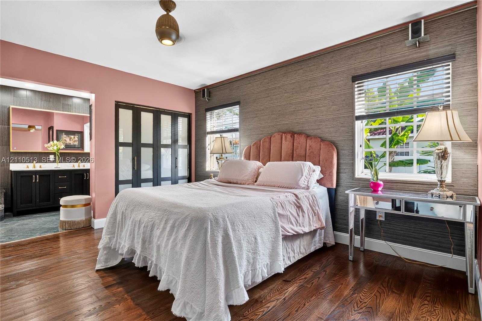 Textured wall covering, wood-finish flooring, multi-pane closet doors, and multi-pane windows