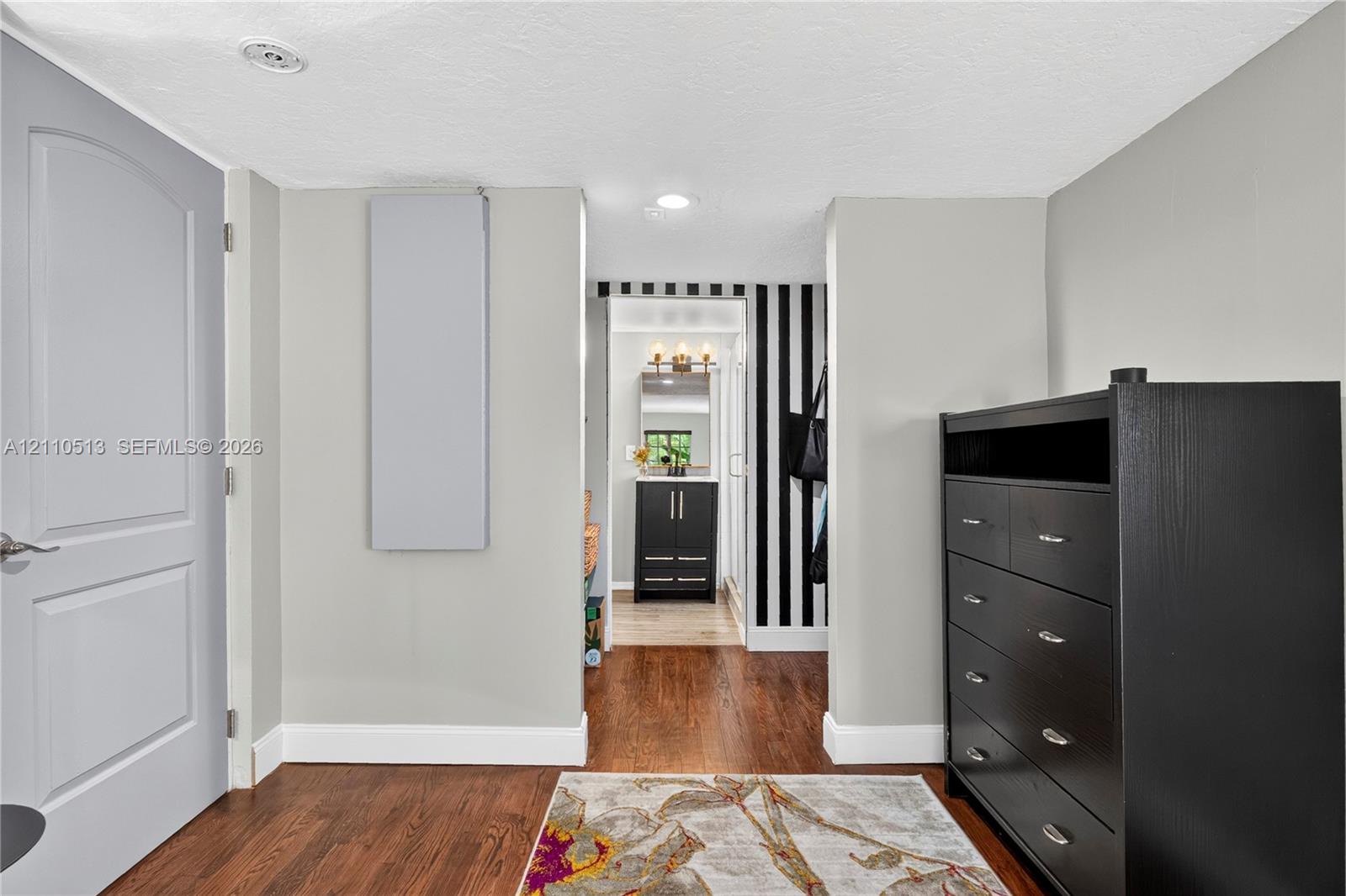 Interior space featuring wood-finish flooring, recessed lighting, and a solid-core panel door