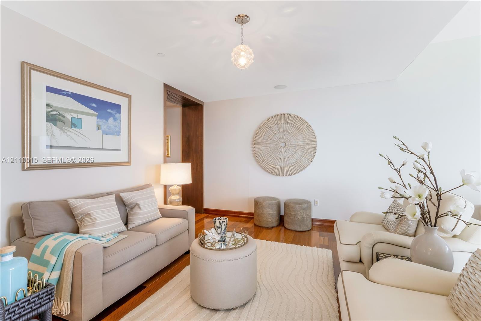 Hardwood flooring, recessed ceiling lighting, and a spherical glass pendant fixture