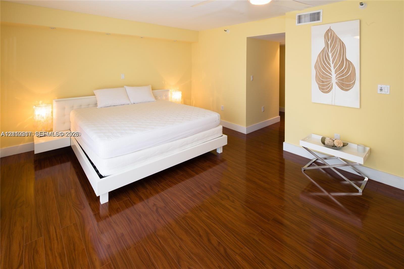 Polished wood-finish flooring complemented by recessed ceiling lighting Polished wood-finish flooring complemented by recessed ceiling lighting