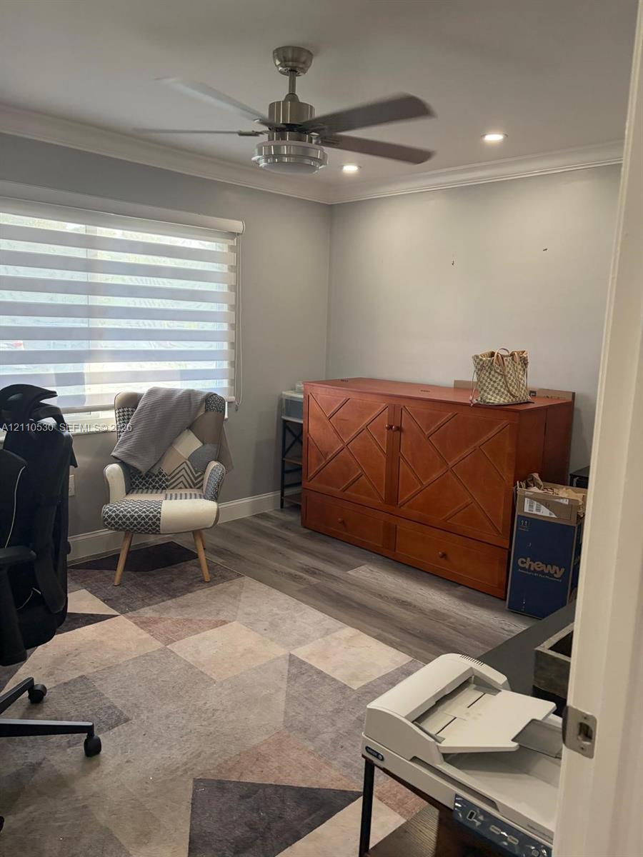 Room featuring neutral wall paint, wood-finish flooring, recessed lighting, and a modern ceiling fan with an integrated light fixture