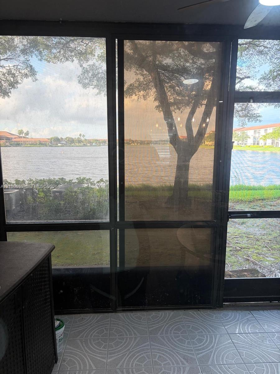 Screened-in patio with geometric tile flooring and full-height metal-framed screening