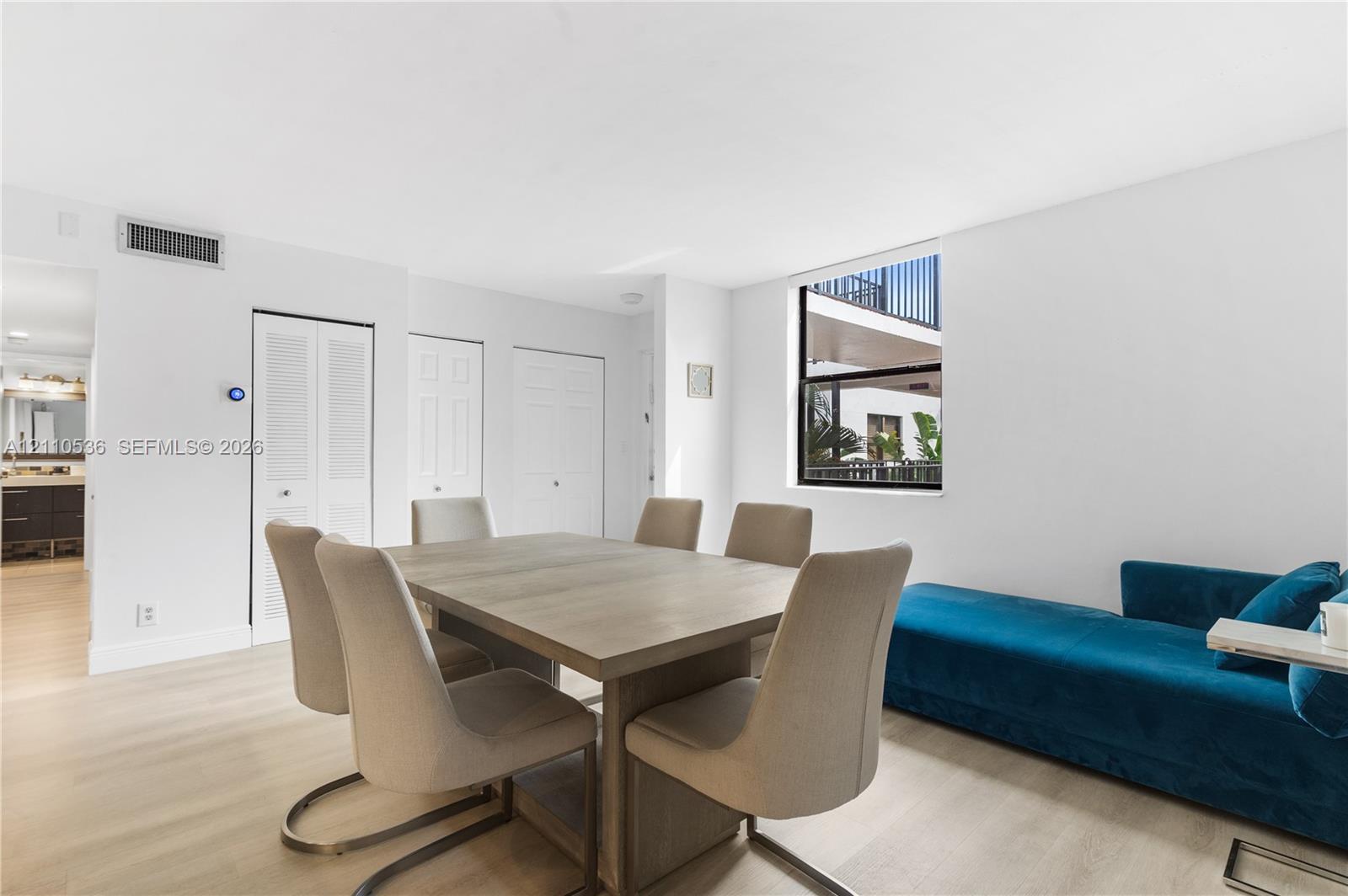 Neutral interior featuring light wood-finish flooring, recessed lighting, and a square window Neutral interior featuring light wood-finish flooring, recessed lighting, and a square window