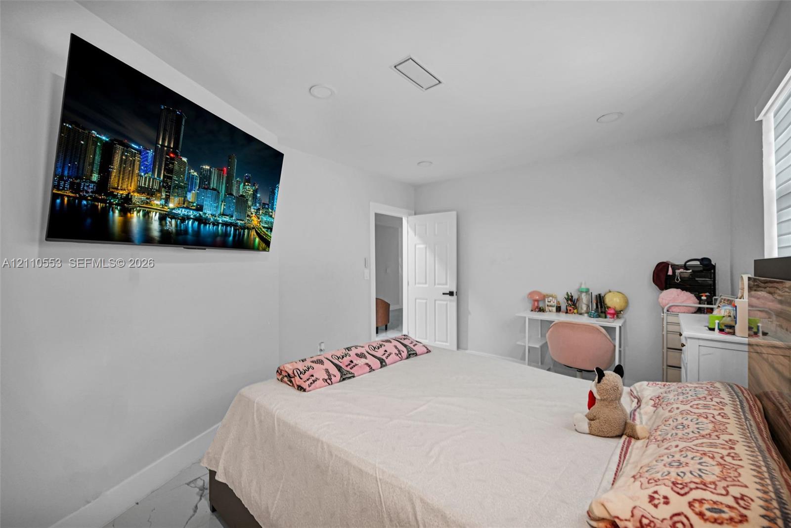 Room featuring recessed lighting, stone-finish flooring, and a panel door with matte black hardware
