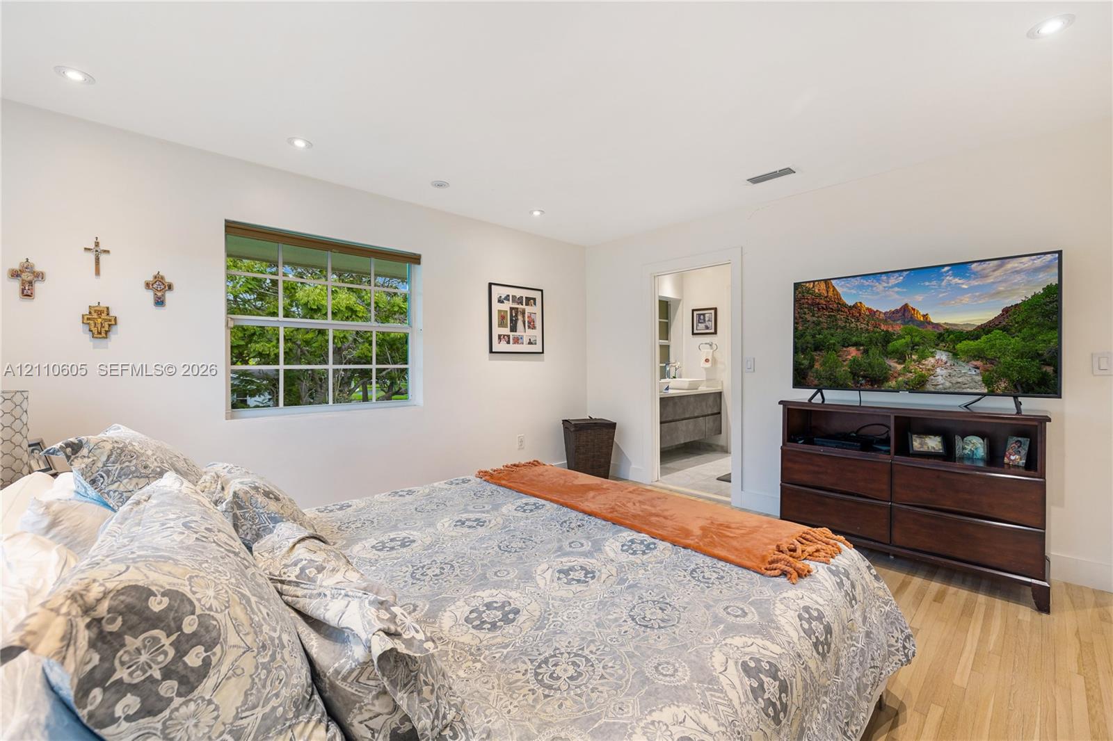 Room featuring recessed lighting, wood-finish flooring, and a multi-pane window