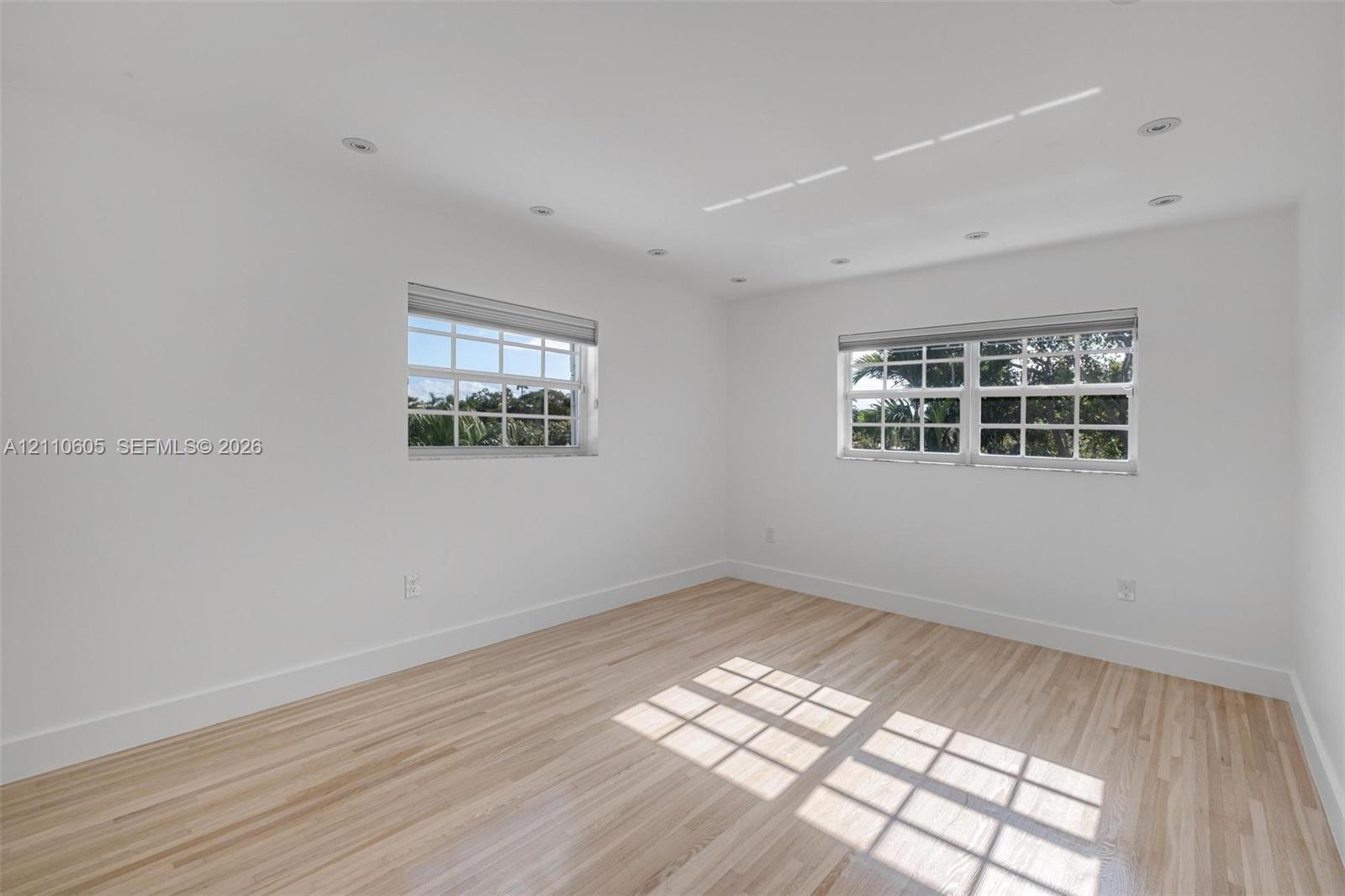 Interior space featuring wood-finish flooring, recessed ceiling lighting, and multi-pane windows