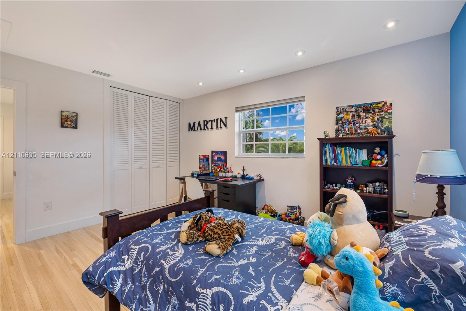 Light-filled room featuring wood-finish flooring, recessed lighting, and a multi-pane window