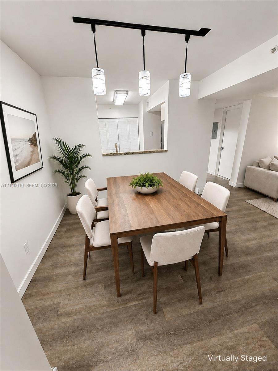 Wood-finish flooring, three-light linear track pendant fixture with frosted glass shades, and interior pass-through window with countertop