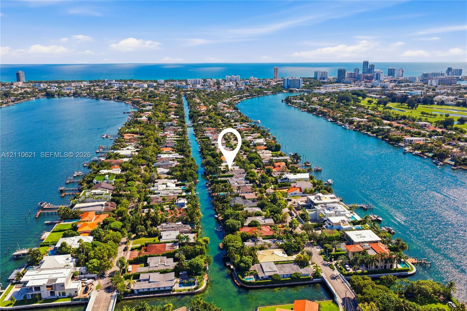 Aerial perspective of a waterfront property situated on a canal with direct access to the ocean and proximity to the city skyline Aerial perspective of a waterfront property situated on a canal with direct access to the ocean and proximity to the city skyline