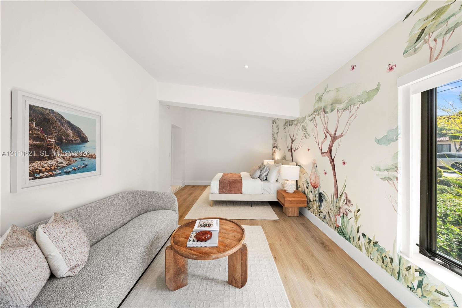 Large-scale illustrative wall mural, wood-finish flooring, and recessed ceiling lighting