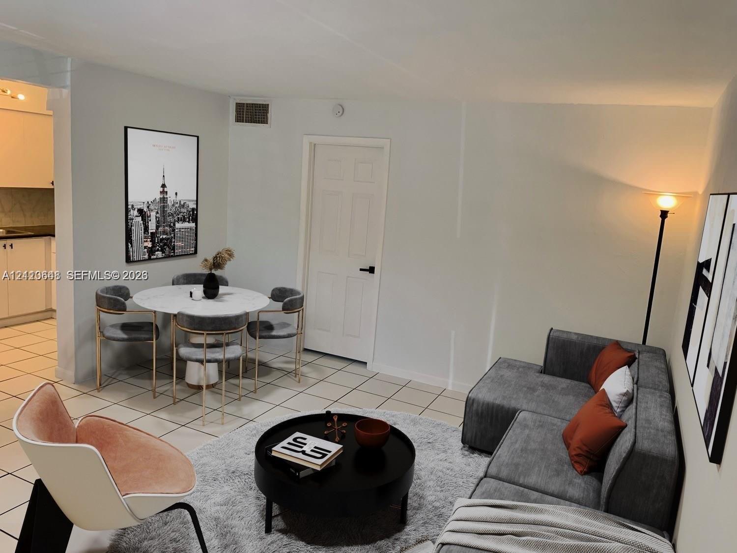 Open-concept interior featuring neutral wall tones and uniform tile flooring