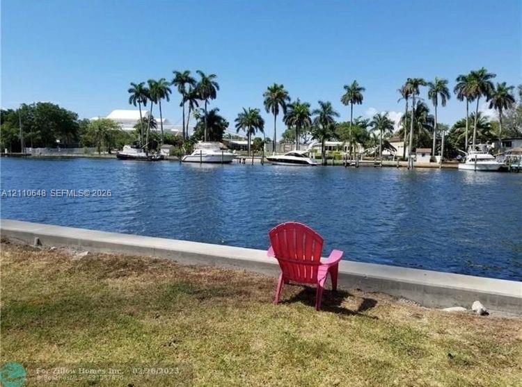 Waterfront property featuring a concrete bulkhead and lawn area Waterfront property featuring a concrete bulkhead and lawn area