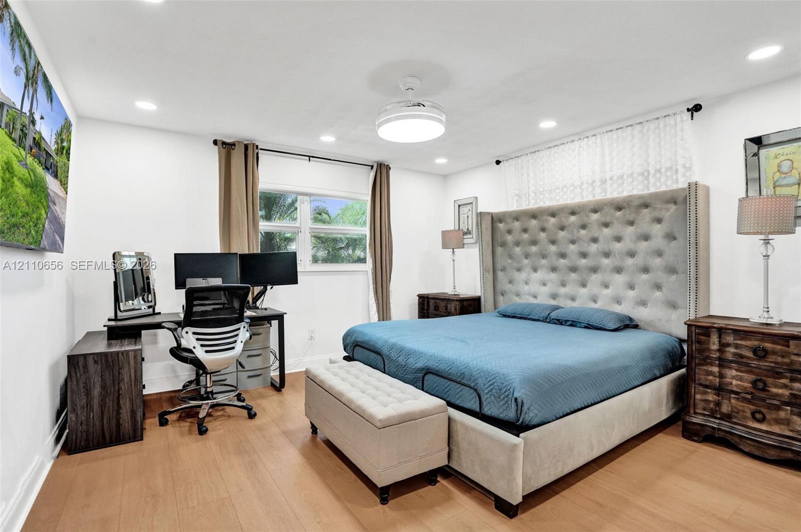Wood-finish flooring, recessed lighting, and a centrally mounted ceiling fan fixture