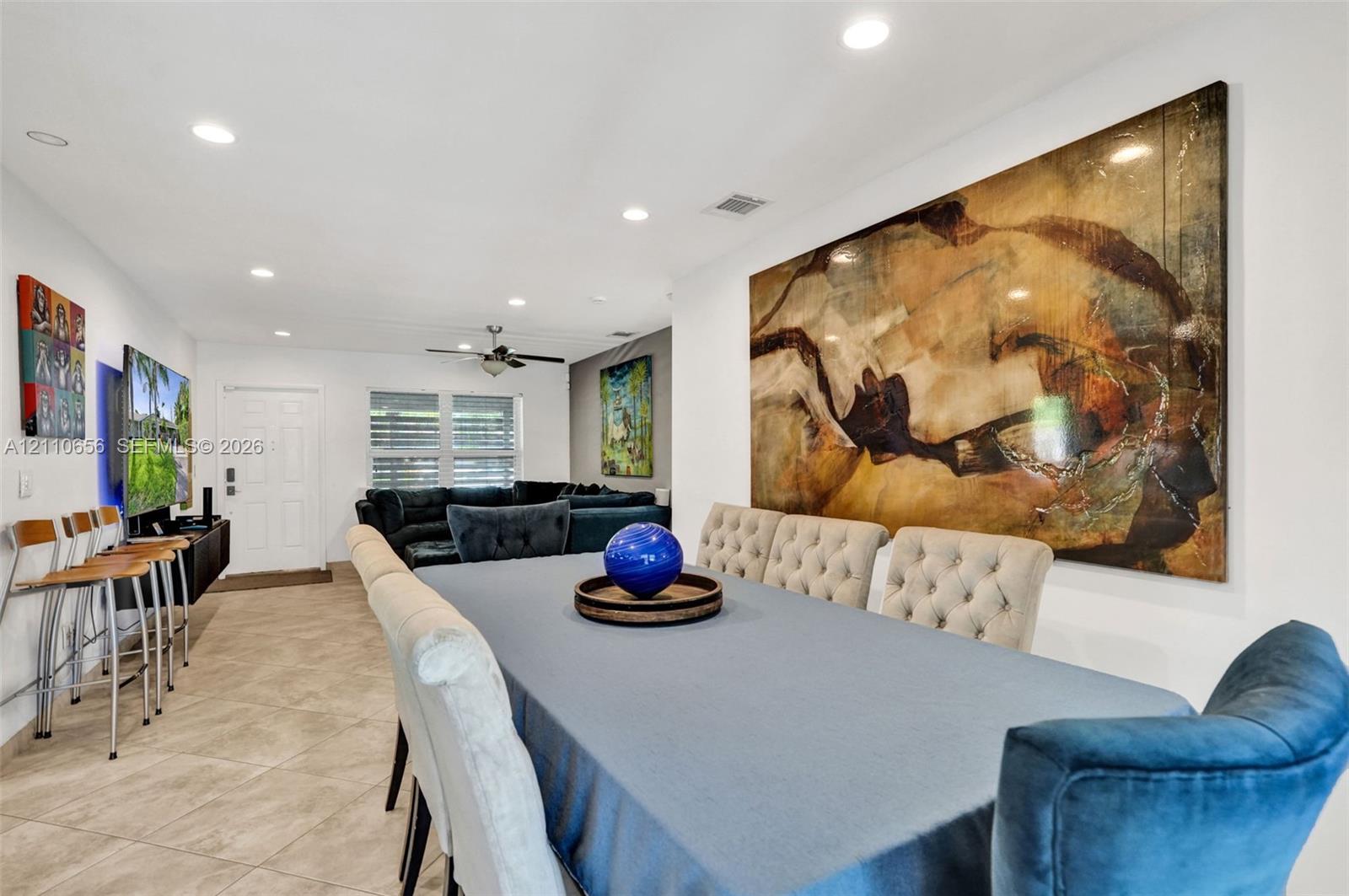 Large interior space featuring neutral tile flooring, recessed lighting, and a ceiling fan